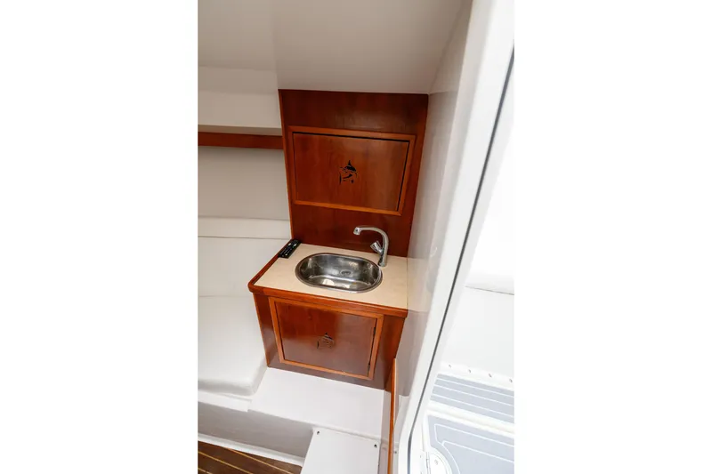 Slide: The Image of 2008 Venture 39 Cuddy interior with wooden cabinetry and compact sink. - 24