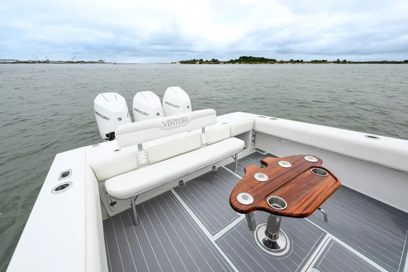 Slide: The Image of 2008 Venture 39 Cuddy boat with triple Mercury engines, spacious deck, and elegant seating. - 19