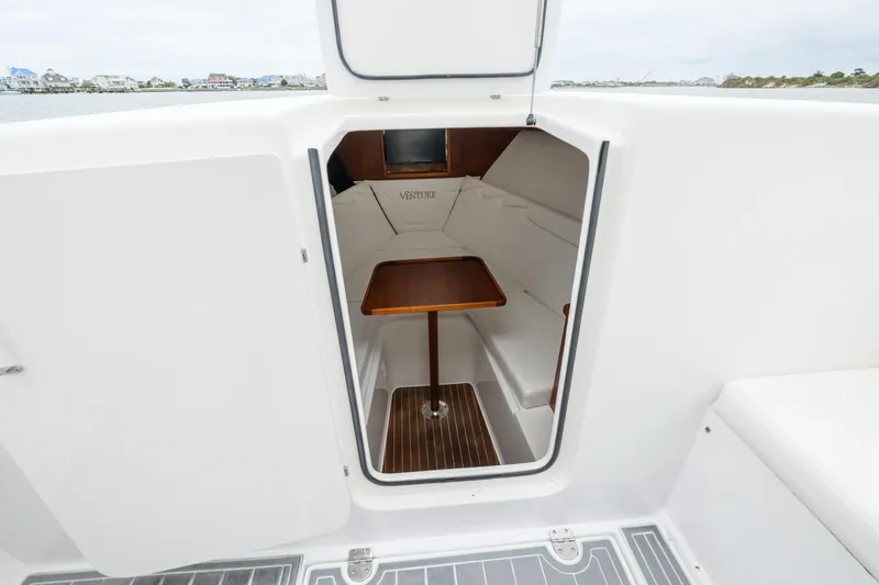 Slide: The Image of 2008 Venture 39 Cuddy cabin interior with seating and wooden table. - 26
