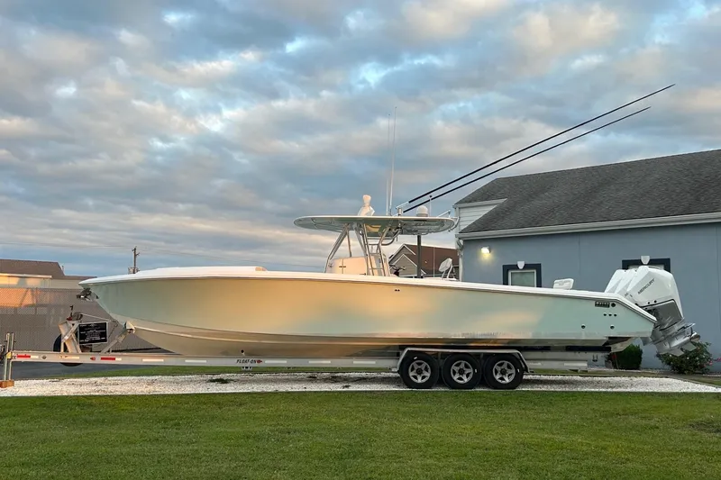 Slide: The Image of 2008 Venture 39 Cuddy boat on trailer, parked outdoors under cloudy sky. - 31