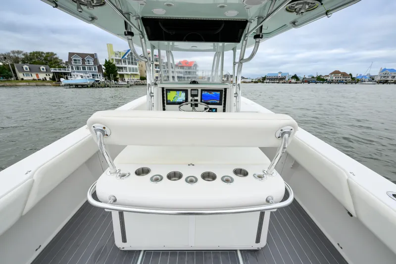 Slide: The Image of 2008 Venture 39 Cuddy boat interior with helm, cup holders, and waterfront view. - 18