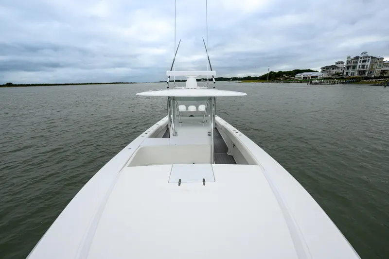 Slide: The Image of 2008 Venture 39 Cuddy boat on calm waters, overcast sky, coastal homes in background. - 27