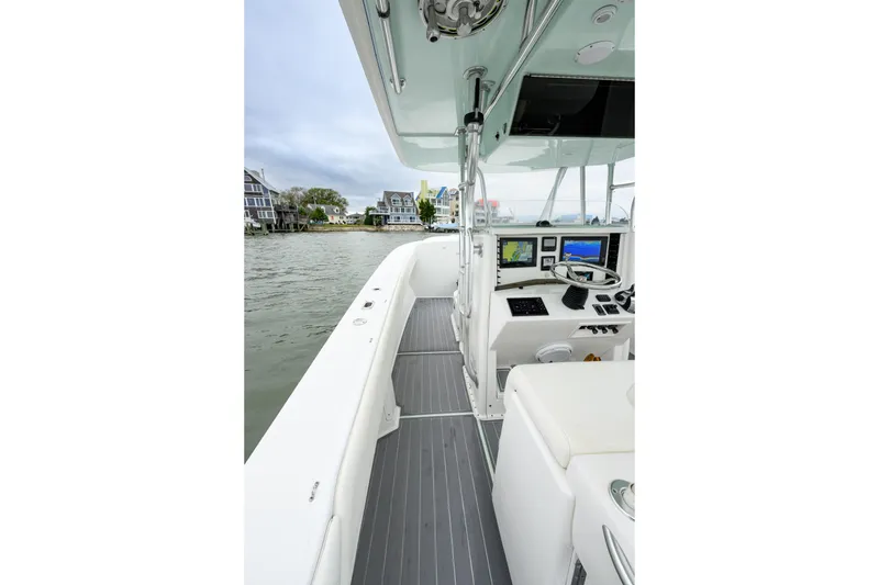 Slide: The Image of 2008 Venture 39 Cuddy boat interior with navigation equipment and waterfront view. - 14