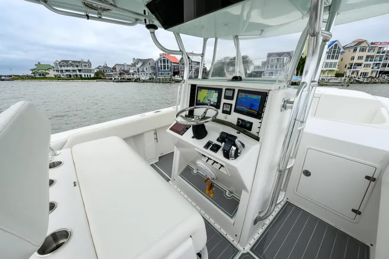 Slide: The Image of 2008 Venture 39 Cuddy boat interior with modern navigation equipment and waterfront view. - 16