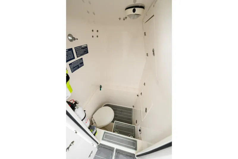 Slide: The Image of 2008 Venture 39 Cuddy boat interior with compact bathroom and toilet. - 13