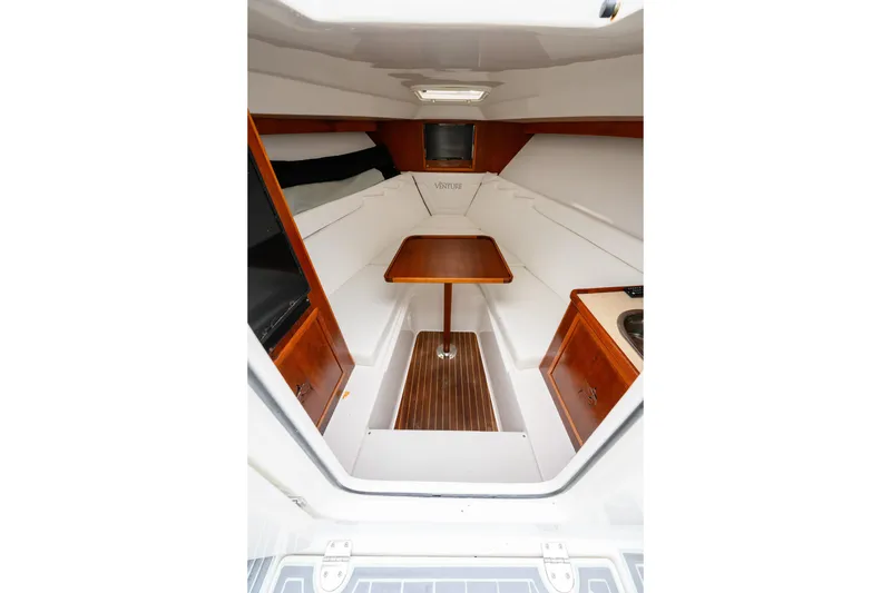 Slide: The Image of 2008 Venture 39 Cuddy interior with wood accents, seating, and compact table. - 23