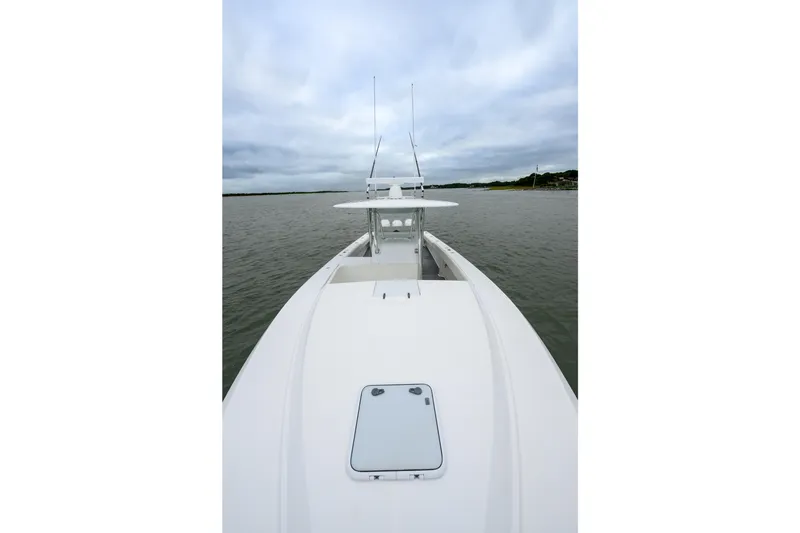 Slide: The Image of 2008 Venture 39 Cuddy boat on calm water under cloudy sky. - 28