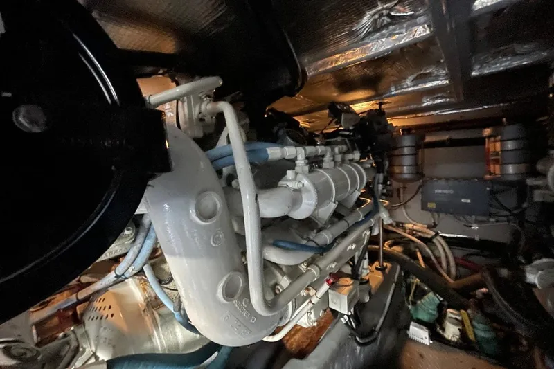 Slide: The Image of Engine room of a 1998 Sea Ray 480 Sedan Bridge yacht, showcasing mechanical components. - 100