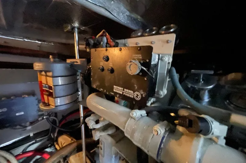 Slide: The Image of Engine room of 1998 Sea Ray 480 Sedan Bridge with diesel power components. - 102