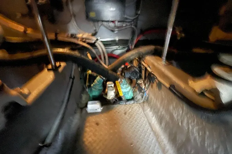 Slide: The Image of Engine room of a 1998 Sea Ray 480 Sedan Bridge with visible wiring and components. - 103
