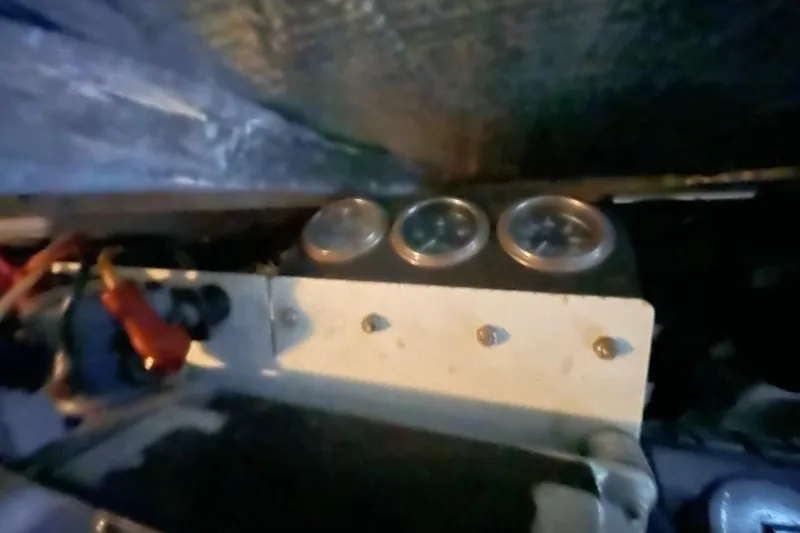 Slide: The Image of 1998 Sea Ray 480 Sedan Bridge engine compartment with gauges and wiring. - 105