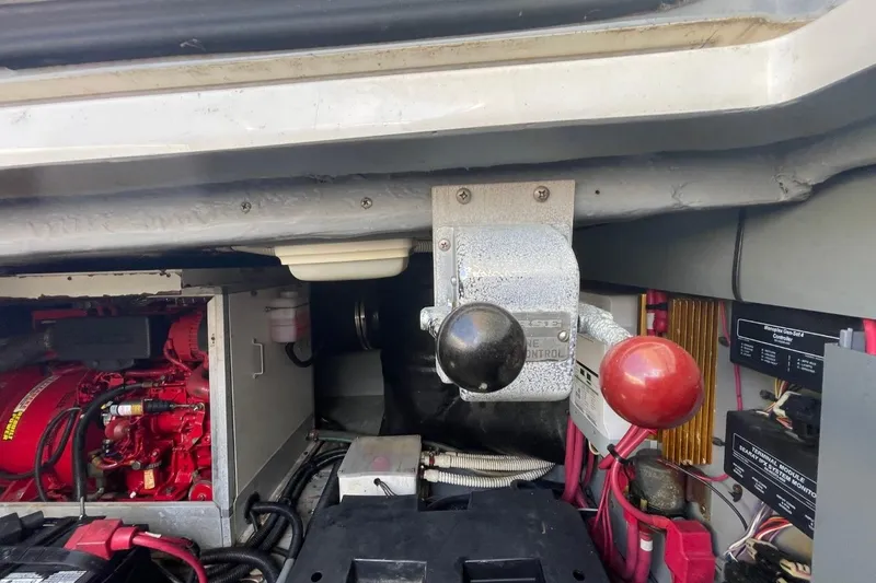 Slide: The Image of Engine room of 1998 Sea Ray 480 Sedan Bridge with control levers and wiring. - 106