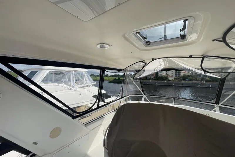 Slide: The Image of Interior view of a 1998 Sea Ray 480 Sedan Bridge yacht with waterway backdrop. - 16