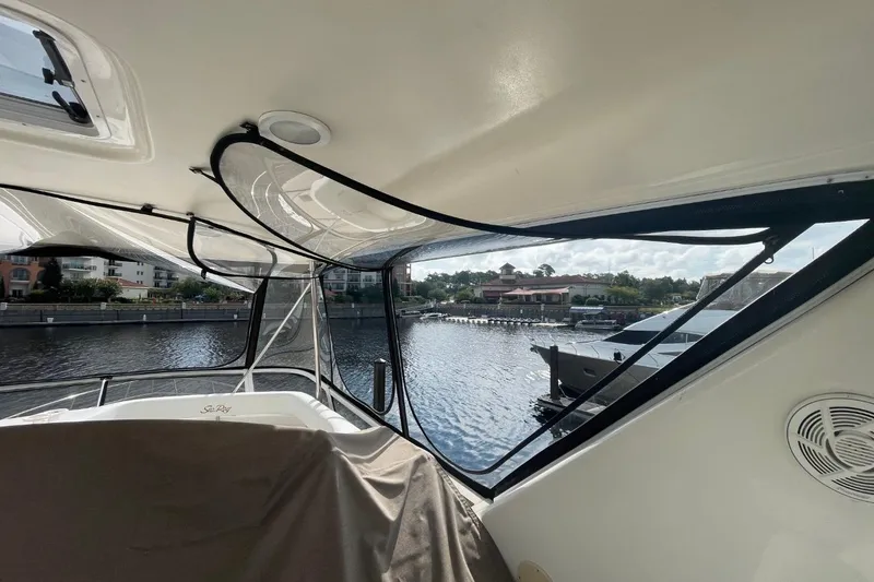 Slide: The Image of Interior view of 1998 Sea Ray 480 Sedan Bridge yacht overlooking marina. - 17