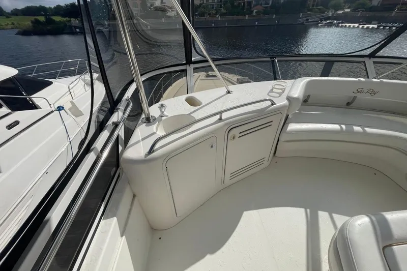 Slide: The Image of 1998 Sea Ray 480 Sedan Bridge yacht interior with seating and water view. - 20