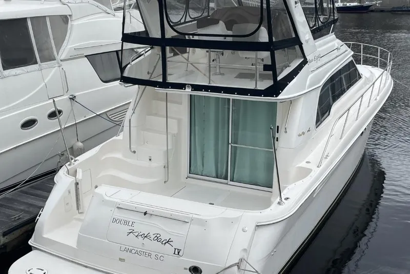Slide: The Image of 1998 Sea Ray 480 Sedan Bridge yacht docked at marina, rear view. - 3