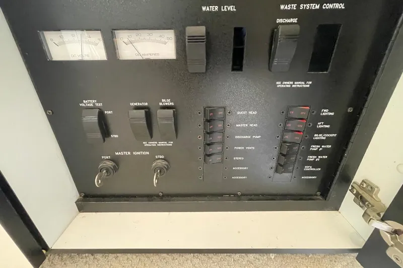 Slide: The Image of Control panel of a 1998 Sea Ray 480 Sedan Bridge yacht with switches and gauges. - 32