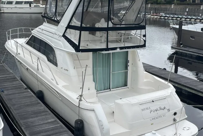 Slide: The Image of 1998 Sea Ray 480 Sedan Bridge yacht docked at marina, rear view. - 4