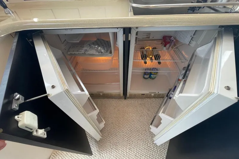 Slide: The Image of Interior view of 1998 Sea Ray 480 Sedan Bridge yacht's dual refrigerators. - 40