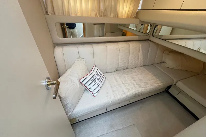 Slide: The Image of 1998 Sea Ray 480 Sedan Bridge interior cabin with beige seating and decorative pillow. - 45
