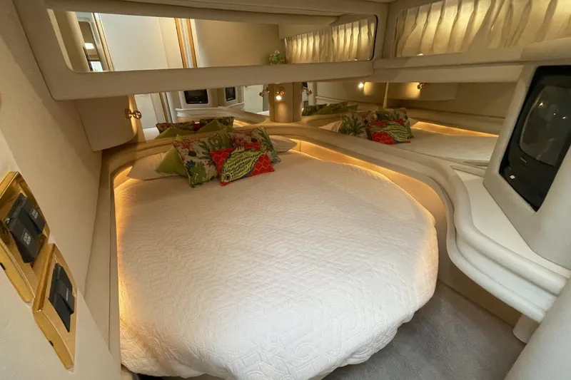 Slide: The Image of Luxurious 1998 Sea Ray 480 Sedan Bridge yacht bedroom with elegant bedding and ambient lighting. - 48