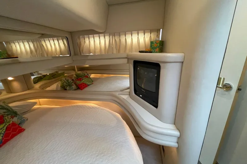 Slide: The Image of Luxurious 1998 Sea Ray 480 Sedan Bridge cabin with cozy bed and vintage TV. - 49
