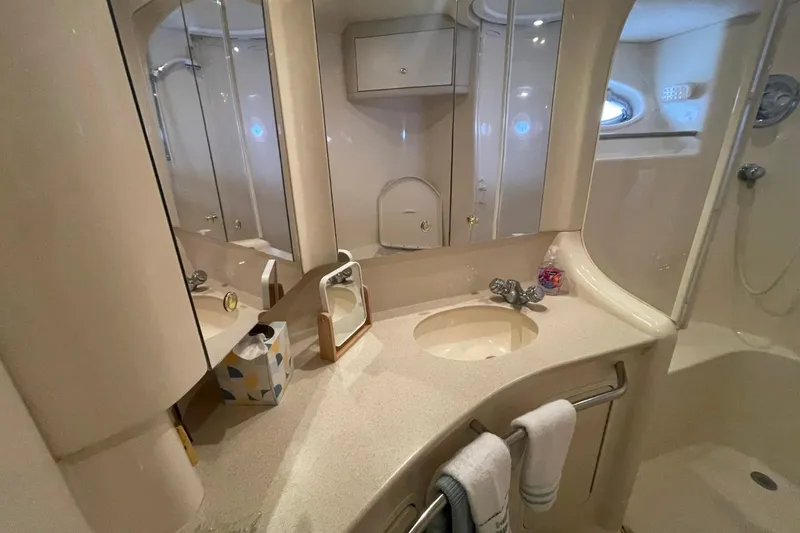 Slide: The Image of Luxurious bathroom in 1998 Sea Ray 480 Sedan Bridge yacht, featuring elegant fixtures and ample storage. - 58