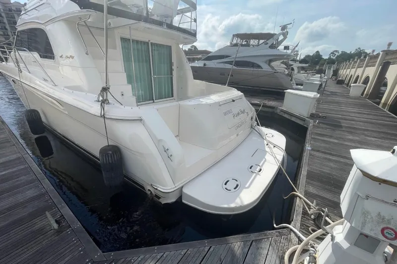 Slide: The Image of 1998 Sea Ray 480 Sedan Bridge yacht docked at marina, rear view. - 6