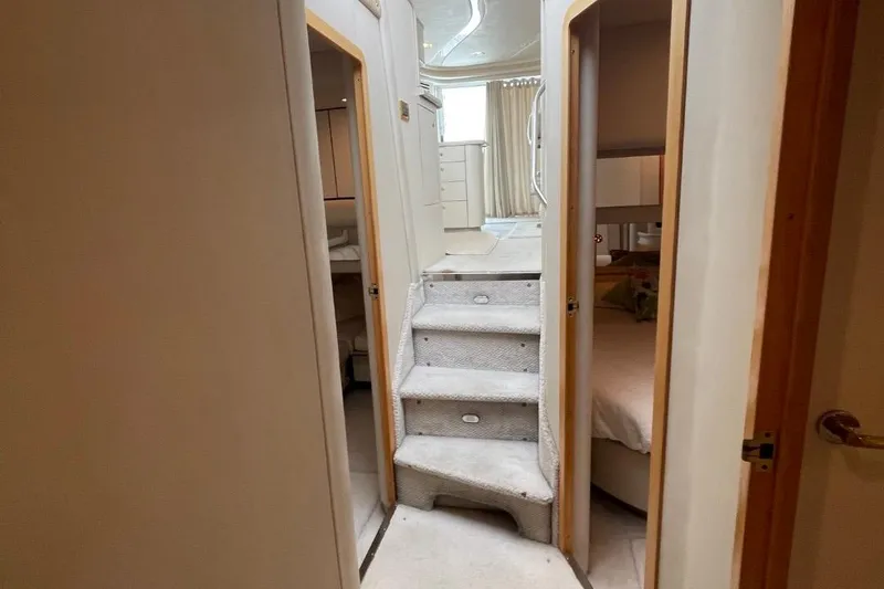 Slide: The Image of Interior of 1998 Sea Ray 480 Sedan Bridge yacht with carpeted stairs and cozy cabins. - 62