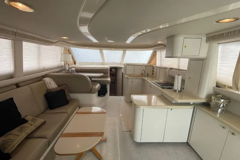 Slide: The Image of Luxurious interior of a 1998 Sea Ray 480 Sedan Bridge yacht with modern kitchen and seating. - 66