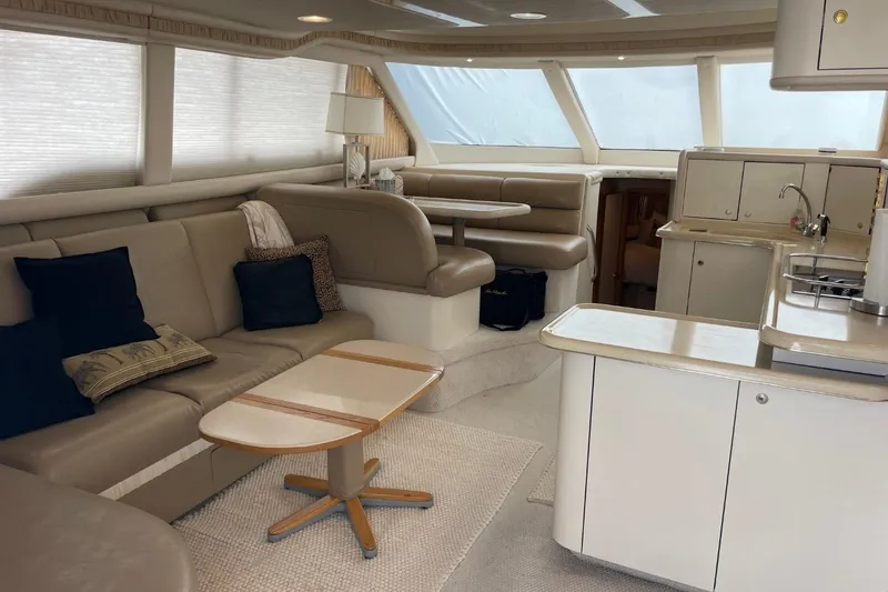 Slide: The Image of Luxurious interior of 1998 Sea Ray 480 Sedan Bridge yacht with elegant seating and kitchen area. - 67