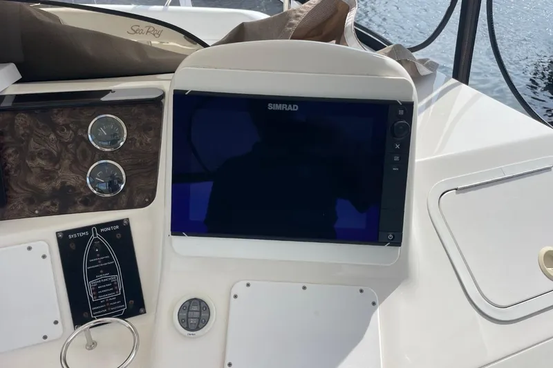 Slide: The Image of Control panel of a 1998 Sea Ray 480 Sedan Bridge with Simrad display. - 70