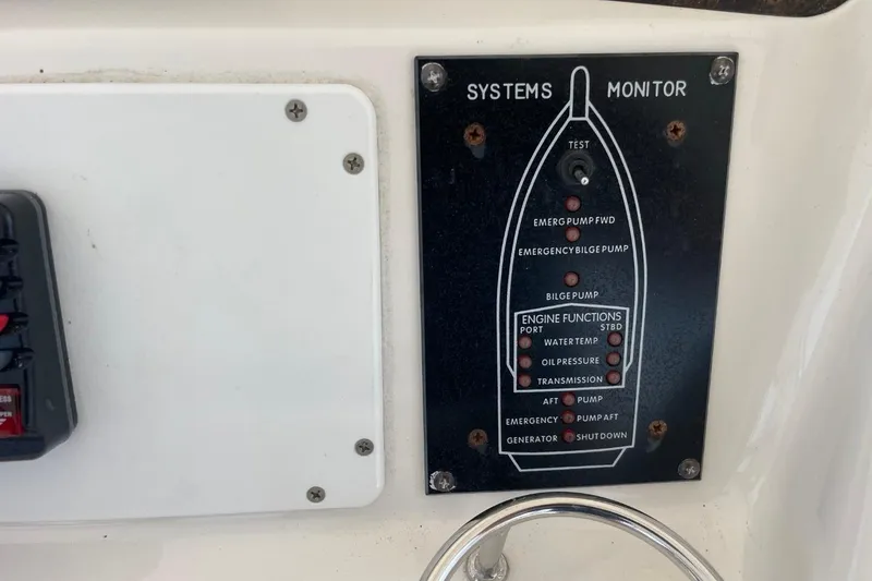 Slide: The Image of Control panel of a 1998 Sea Ray 480 Sedan Bridge boat systems monitor. - 74