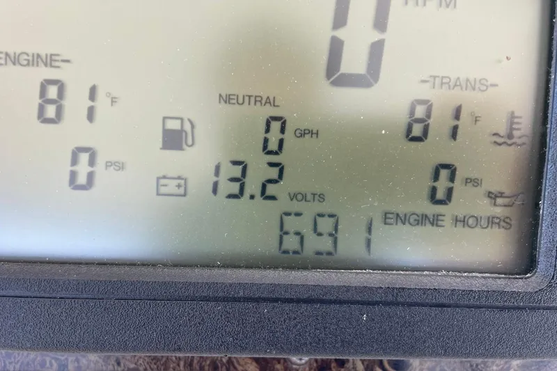 Slide: The Image of 1998 Sea Ray 480 Sedan Bridge dashboard showing engine temperature, voltage, and engine hours. - 79