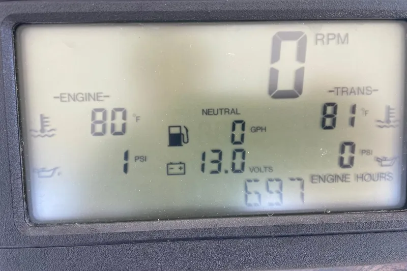 Slide: The Image of Dashboard display of a 1998 Sea Ray 480 Sedan Bridge showing engine and transmission data. - 80