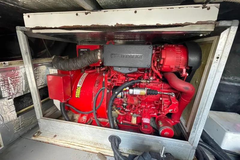 Slide: The Image of Red Westerbeke generator in 1998 Sea Ray 480 Sedan Bridge engine compartment. - 83