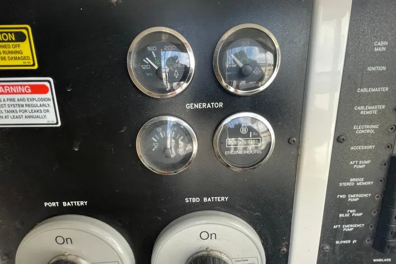 Slide: The Image of Control panel of a 1998 Sea Ray 480 Sedan Bridge with gauges and switches. - 85