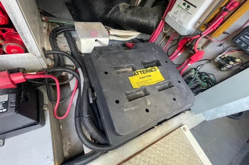 Slide: The Image of Battery compartment of a 1998 Sea Ray 480 Sedan Bridge with wiring and caution label. - 87