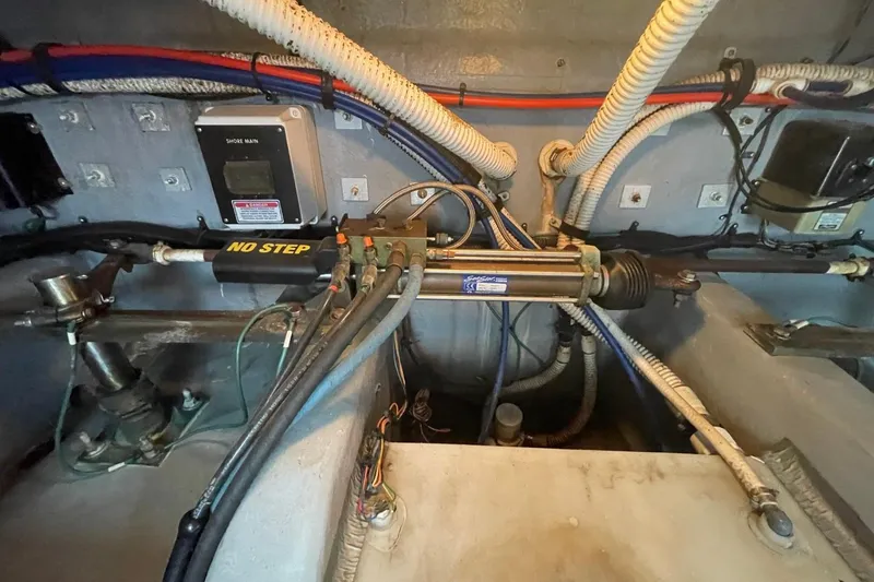 Slide: The Image of Engine room of a 1998 Sea Ray 480 Sedan Bridge with hydraulic steering components. - 88