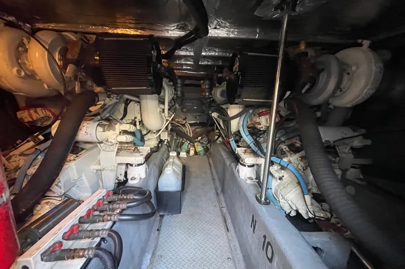 Slide: The Image of Engine room of a 1998 Sea Ray 480 Sedan Bridge yacht, showcasing mechanical components. - 92