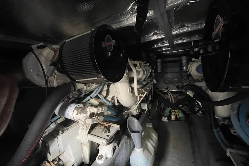 Slide: The Image of Engine room of 1998 Sea Ray 480 Sedan Bridge with visible components and equipment. - 96