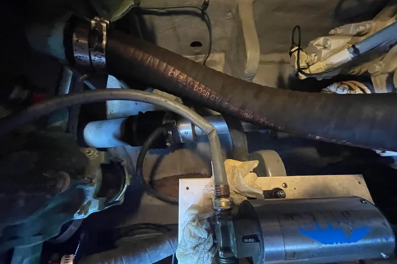 Slide: The Image of Engine compartment of a 1998 Sea Ray 480 Sedan Bridge with hoses and components. - 97