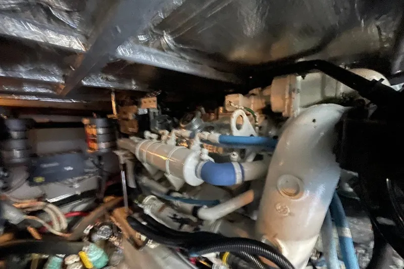 Slide: The Image of Engine room of a 1998 Sea Ray 480 Sedan Bridge with visible components and wiring. - 98
