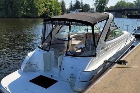 Slide: The Image of 2000 Doral 360 SE boat docked by a serene riverbank. - 1