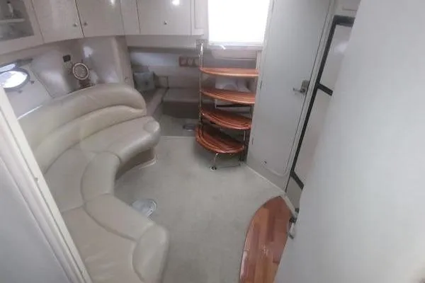 Slide: The Image of Interior of 2000 Doral 360 SE yacht with curved seating and wooden shelves. - 10
