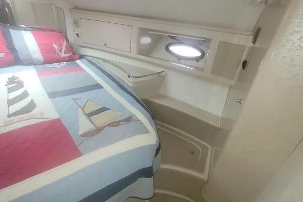 Slide: The Image of Interior cabin of 2000 Doral 360 SE boat with nautical-themed bedding. - 12