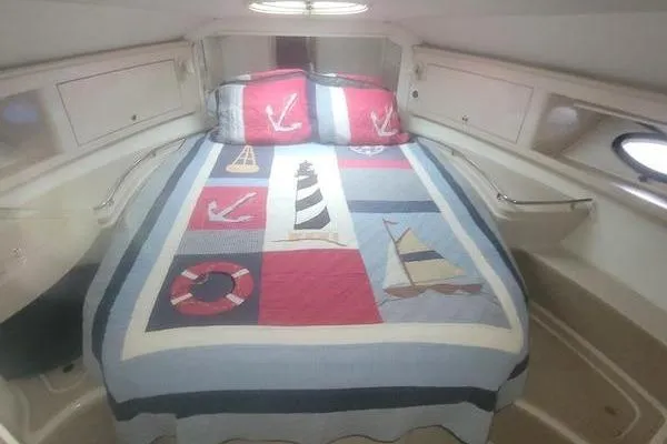 Slide: The Image of Cozy cabin interior of 2000 Doral 360 SE with nautical-themed bedding. - 13
