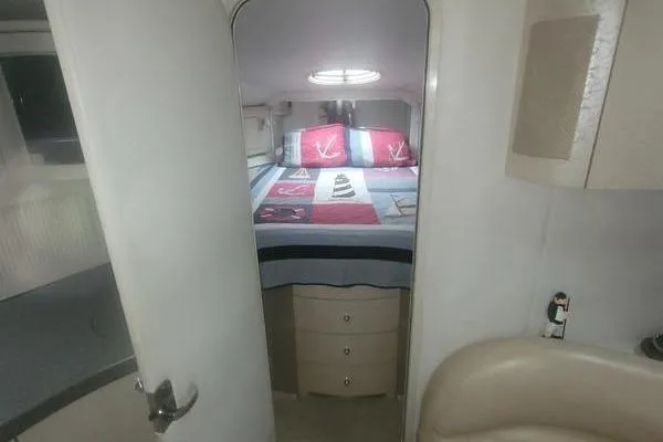 Slide: The Image of Interior cabin of a 2000 Doral 360 SE boat with nautical-themed bedding. - 14