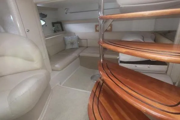 Slide: The Image of Interior of 2000 Doral 360 SE yacht with wooden stairs and beige seating area. - 16