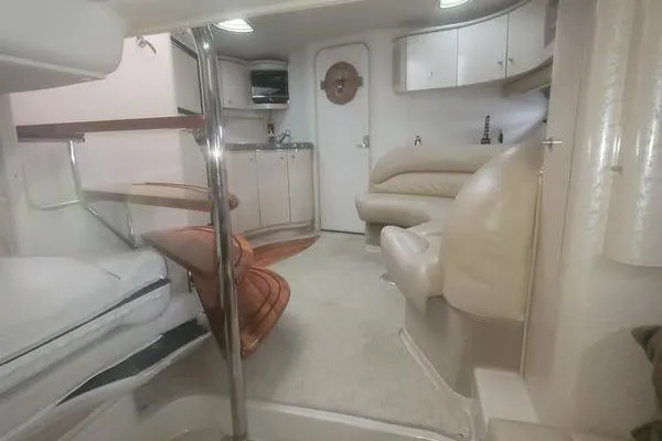 Slide: The Image of Interior of a 2000 Doral 360 SE boat, featuring a cozy cabin layout. - 17